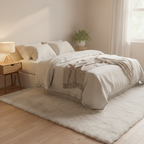 White plush faux fur area rug in cozy bedroom with cream linen bedding and warm natural light